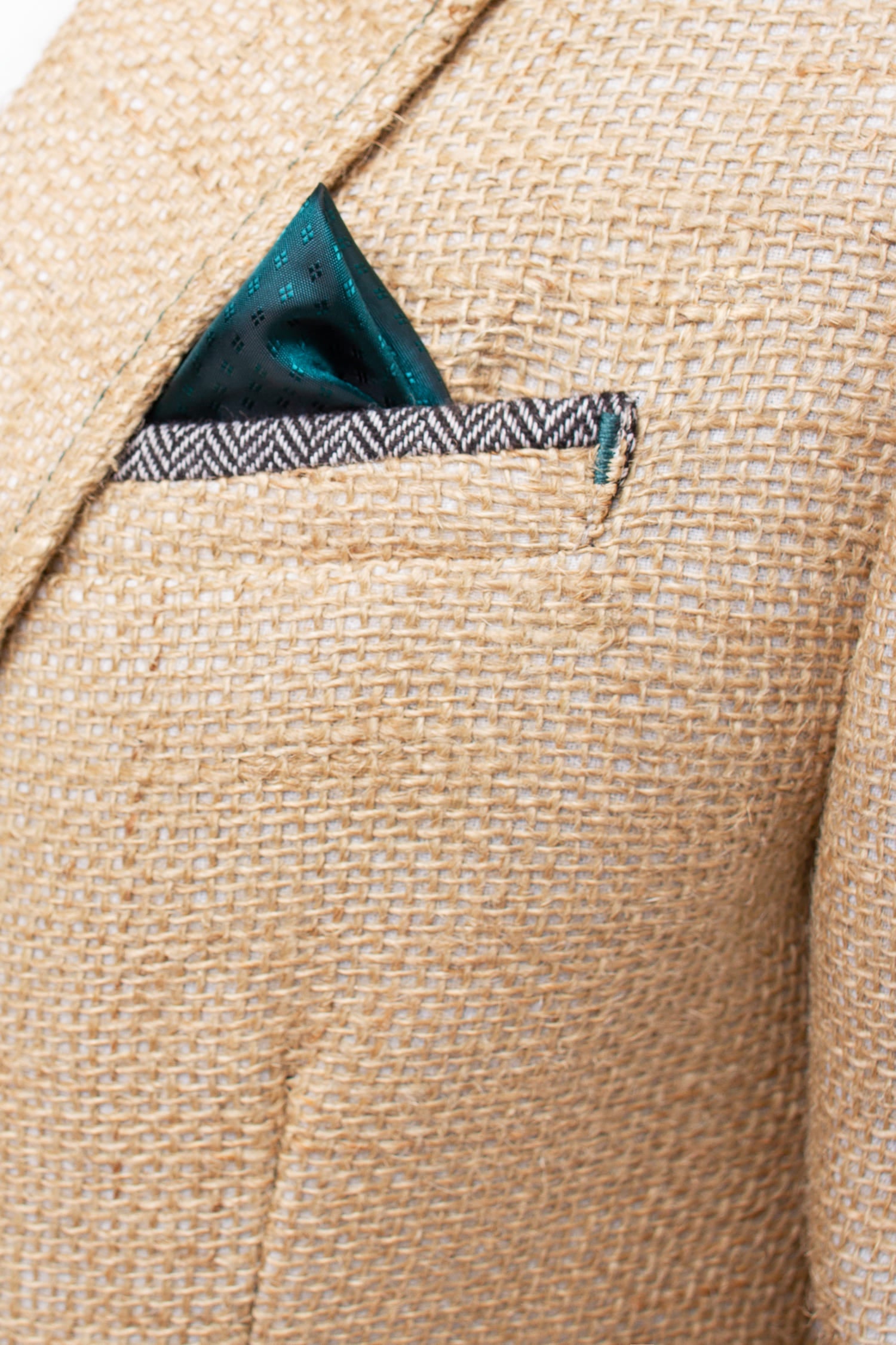 Elegante Herrenjacke aus gebrauchten Kaffeesäcken mit dem smaragdgrünen Einstecktuch in Farbe des Innenfutters