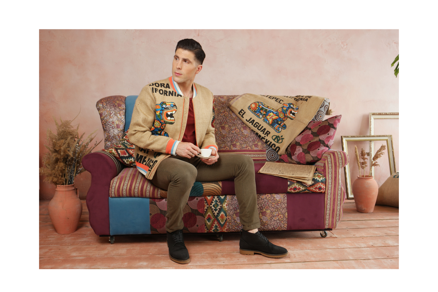 Young man is drinking coffee and wearing a one-off outerwear piece made of upcycled burlap coffee sacks with an eye-catching JAGUAR print