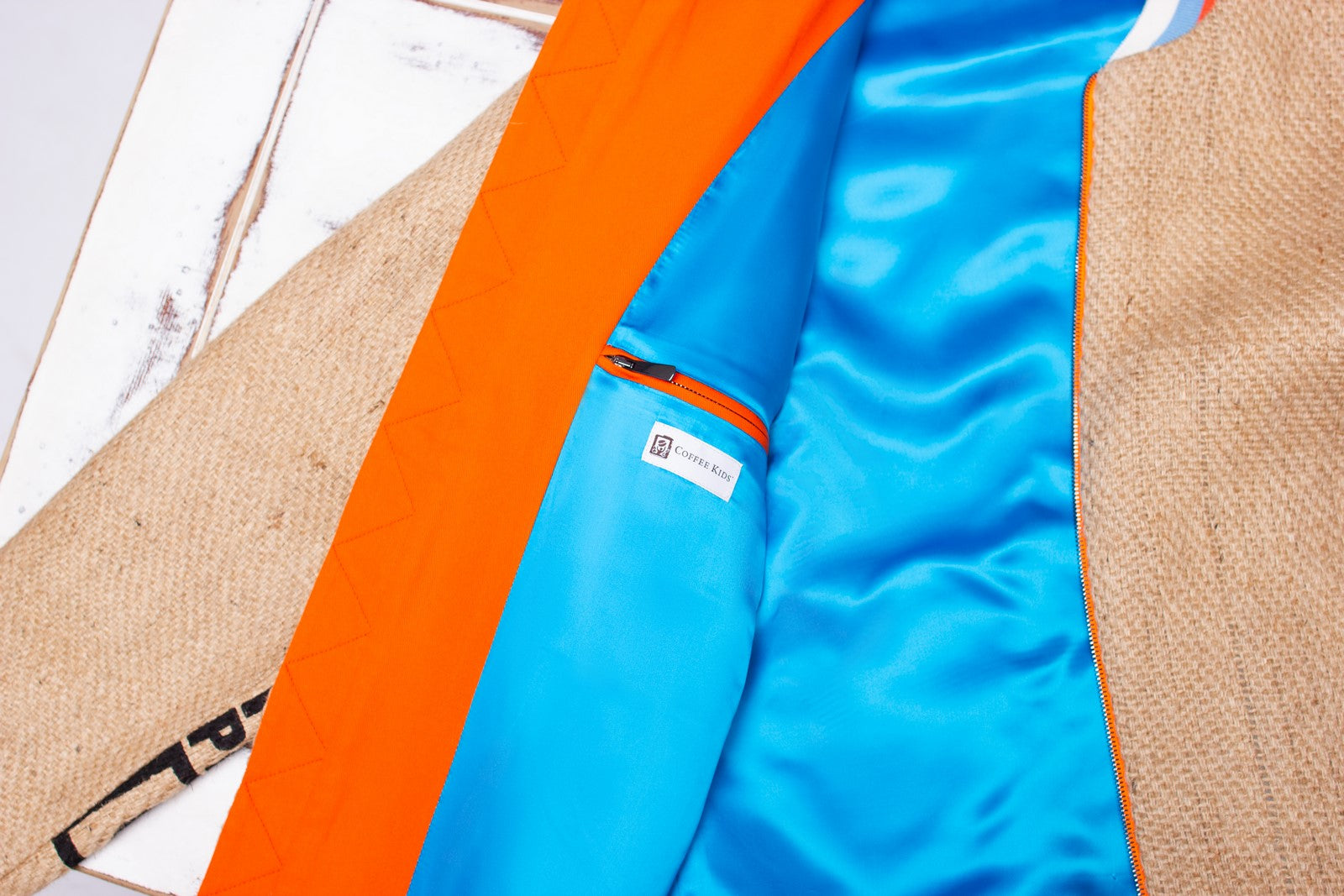 Colourful inner workings in sky blue and sunny orange of an exquisite eco-friendly jacket out of used coffee sacks