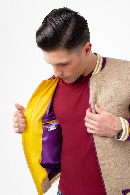 A young man showing the colourful inner working and high-quality workmanship of an exquisite college jacket out of coffee sacks